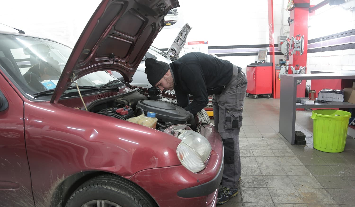 Mechanic man working on a red car