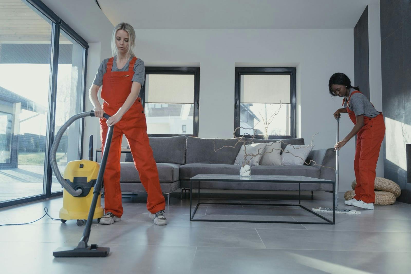 Two women cleaning the floor