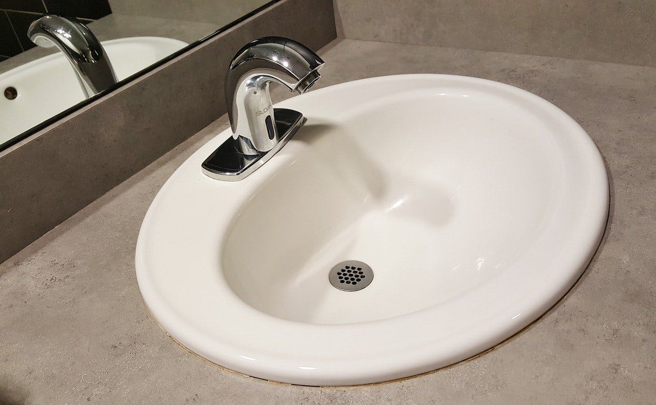Clean bathroom sink with silver faucet.